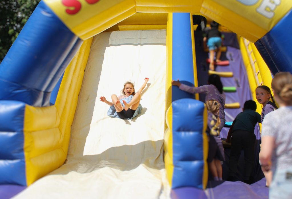 Attendees having fun on the super slide at the event